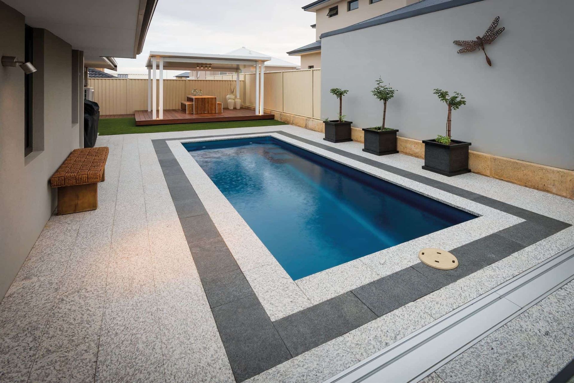 Pool With a Dark Blue Interior, Surrounded by Gray and Light-colored Stone — Creative Pools and Spas in Mornington, VIC