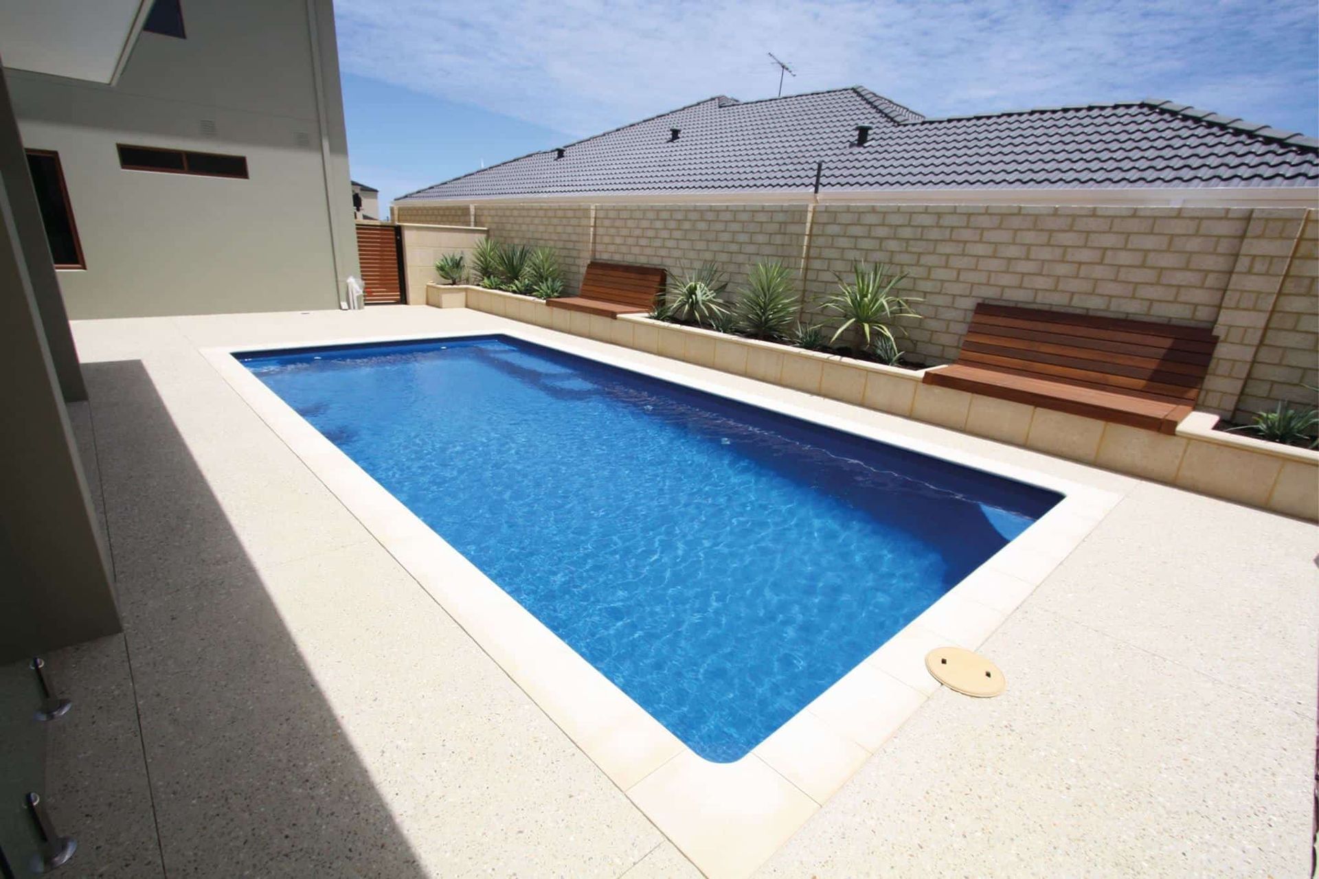 Rectangular Pool With Blue Water, Surrounded by Light Concrete — Creative Pools and Spas in Mount Martha, VIC