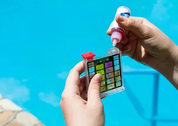 A Person Testing the Quality of Pool Water — Creative Pools and Spas in Mount Eliza, VIC