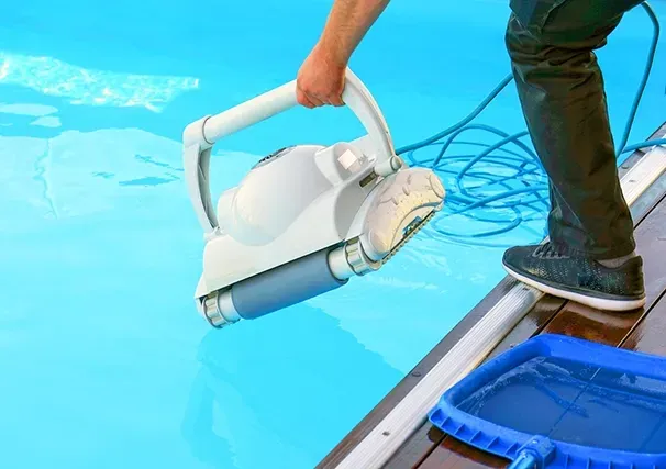 Pool Technician Placing a Vacuum in a Pool — Creative Pools and Spas in Melbourne, VIC