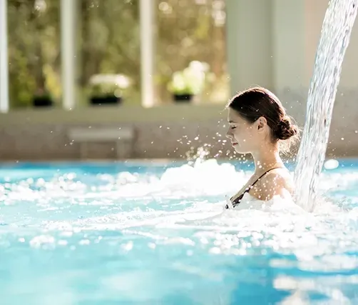 Woman Relaxing in a Pool with Spa — Creative Pools and Spas in Rosebud, VIC