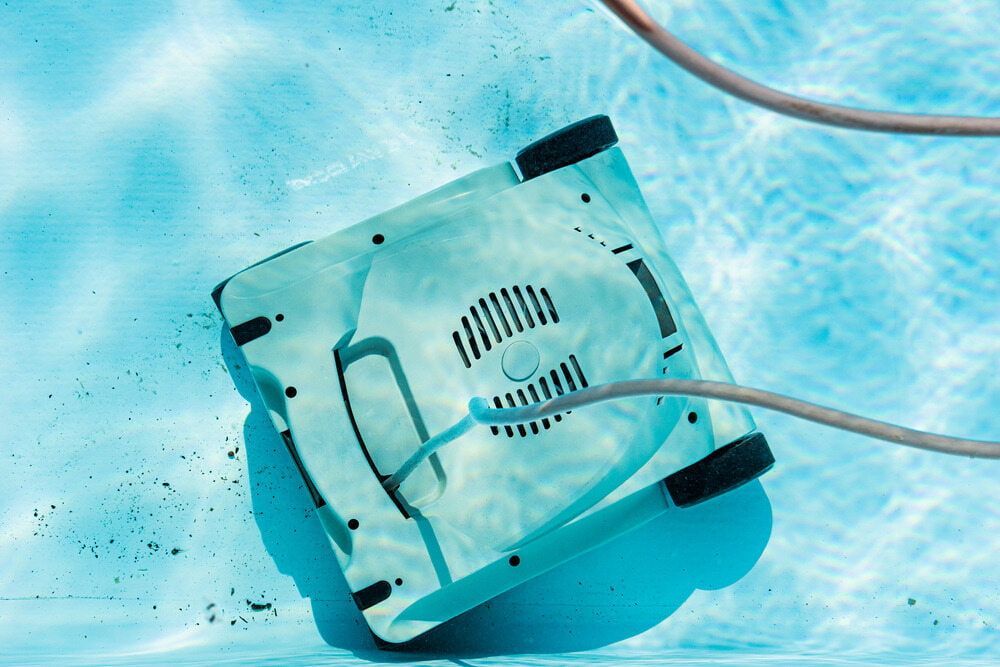 Pool Cleaning Robot Submerged in Pool, Cleaning Debris — Creative Pools and Spas in Mornington, VIC