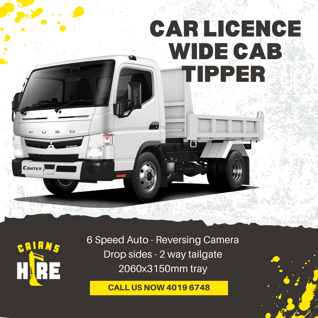 A white dump truck is sitting on top of a black surface.