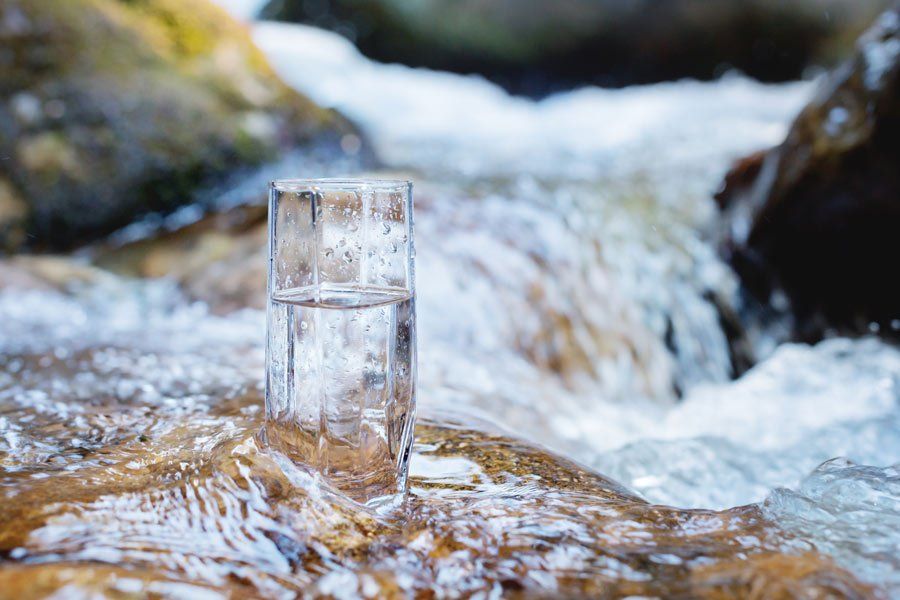 a glass of water in a stream