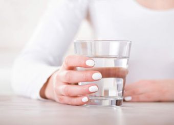 woman holding a glass of water