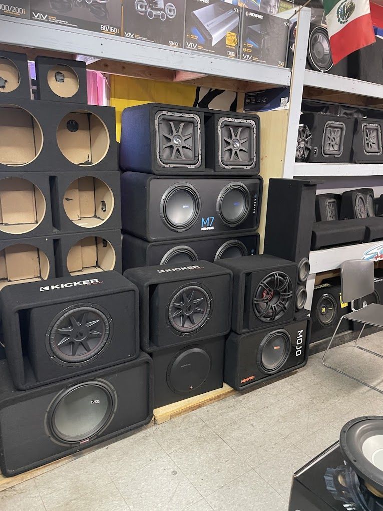 a bunch of speakers are stacked on top of each other in a store .