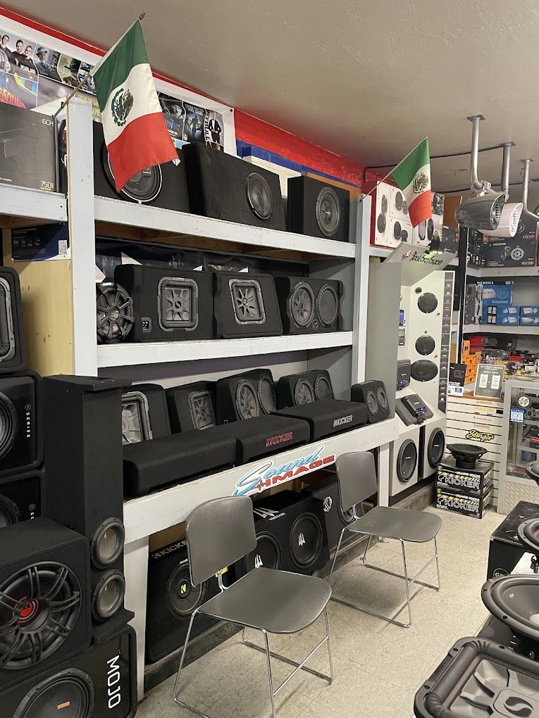 a store filled with lots of speakers and mexican flags .
