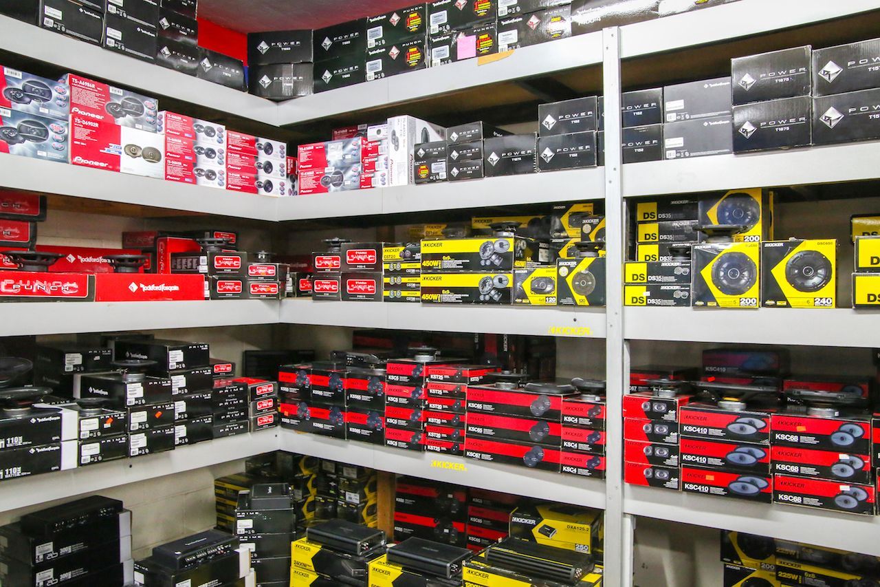 a store filled with shelves filled with boxes of speakers .