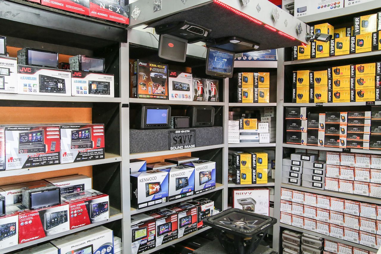 a store filled with shelves filled with boxes of electronics .