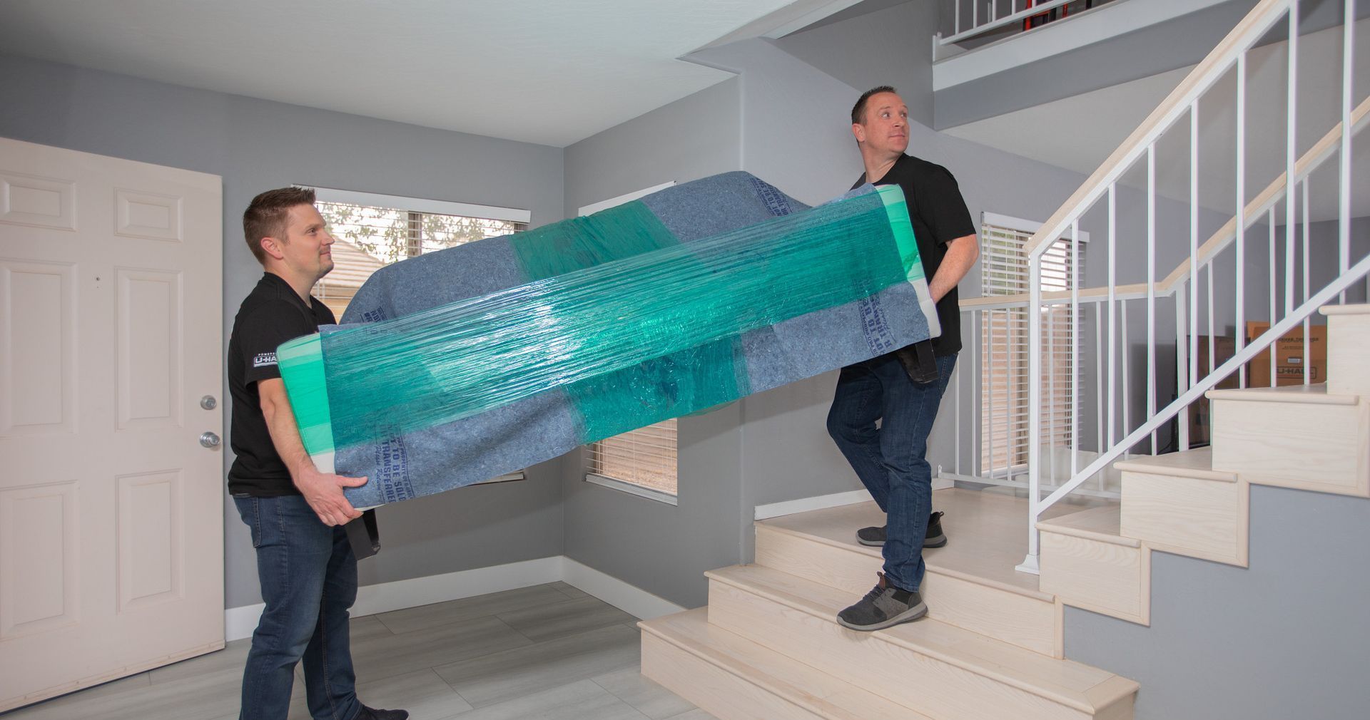 Movers Delivering a couch upstairs in your home