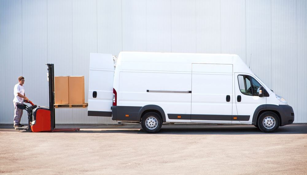 Delivery guy loading courier in Van in Toronto