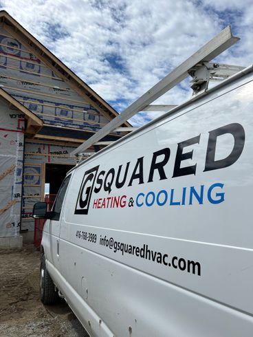 A white van is parked in front of a house under construction.