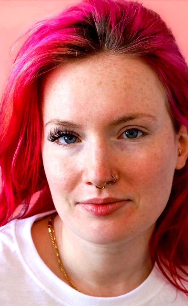 A woman with red hair and freckles is wearing a white shirt and a nose ring | St. Louis, MO | Lashing Out Loud