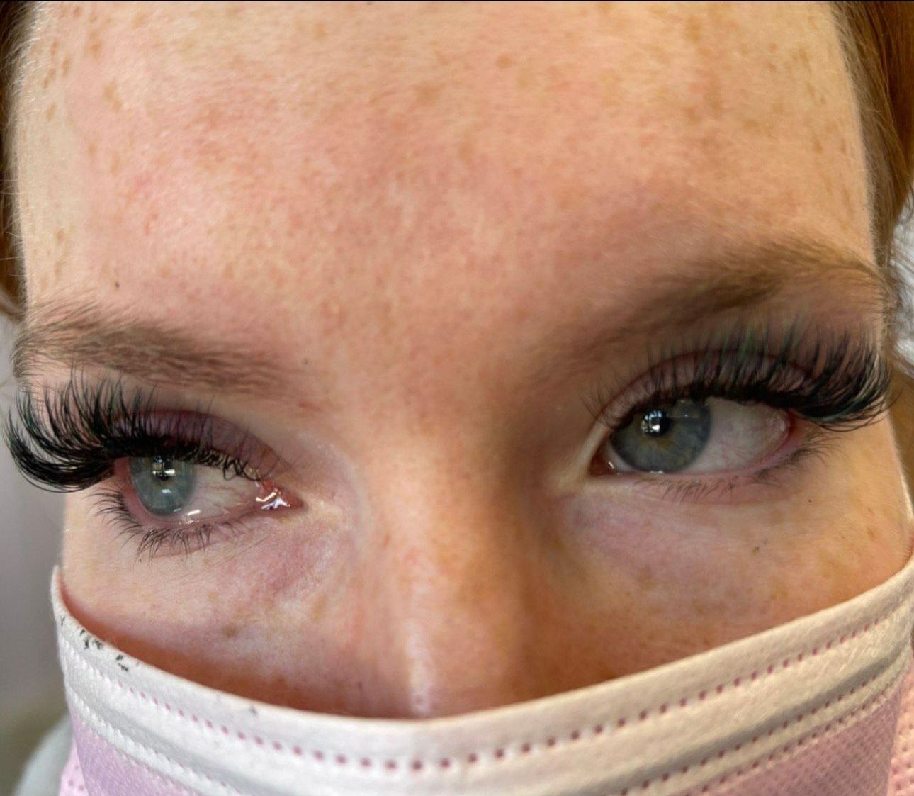A close up of a woman wearing a mask with long eyelashes.| St. Louis, MO | Lashing Out Loud