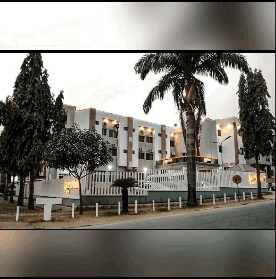 A large building with palm trees in front of it
