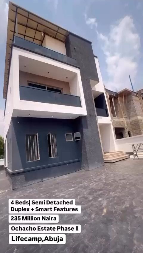 A large house with a lot of windows and balconies is for sale.