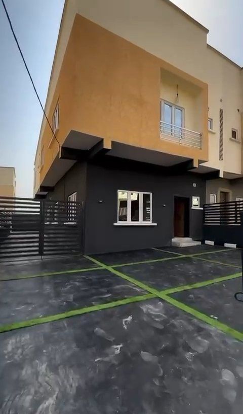 A large building with a window and a fence in front of it