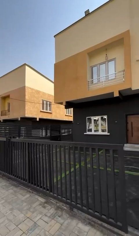 A house with a black fence in front of it