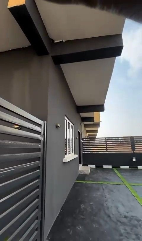 A building with a fence in front of it and a window.