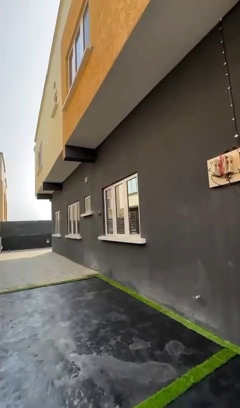 A building with a lot of windows and a parking lot in front of it.