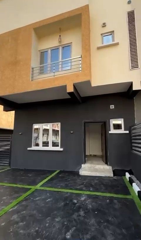 A house with a lot of windows and a balcony is for sale.