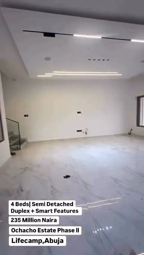 A living room with white walls and a marble floor.