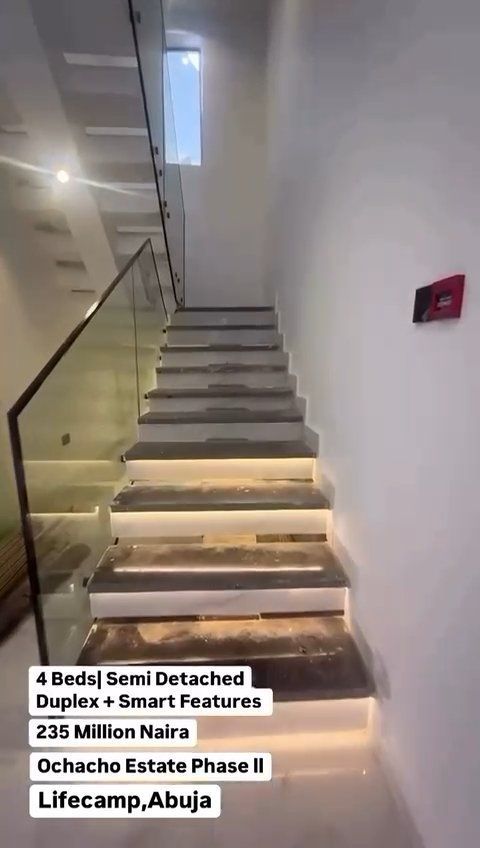 A picture of a staircase with a glass railing.