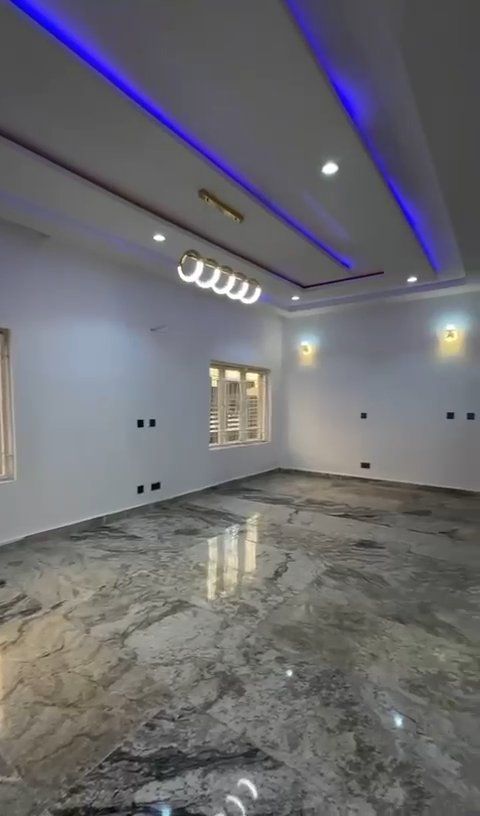 An empty room with a marble floor and white walls