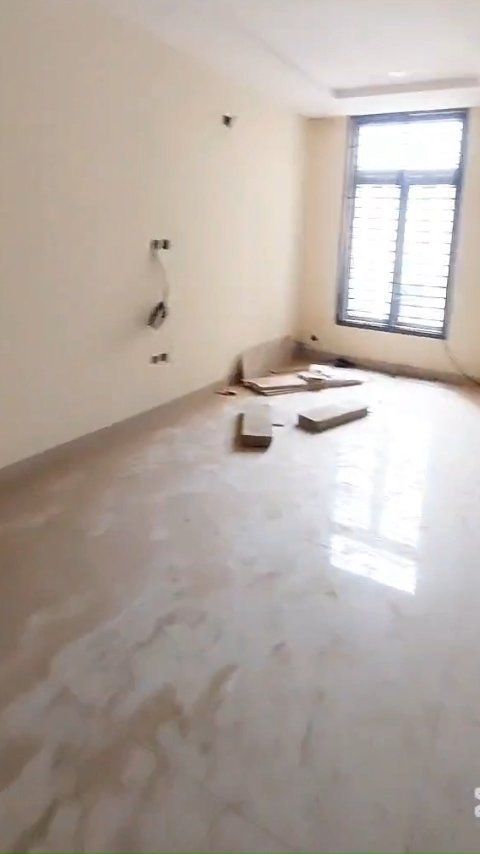 An empty room with a marble floor and a window.