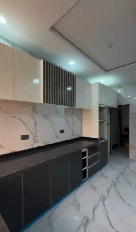 A kitchen with marble counter tops and cabinets