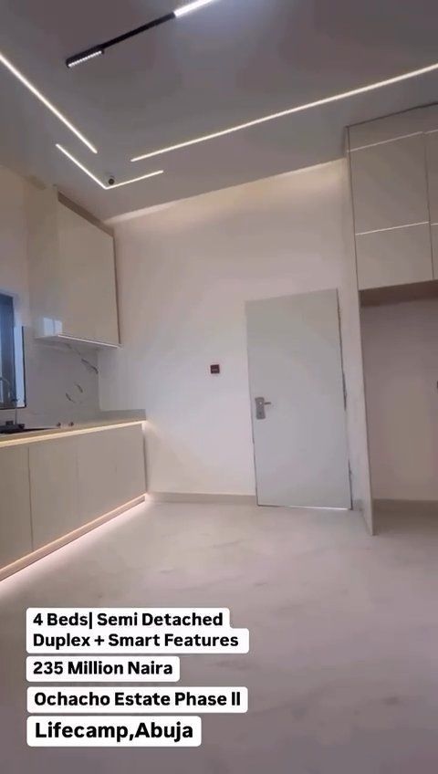 A kitchen with white cabinets and a white door