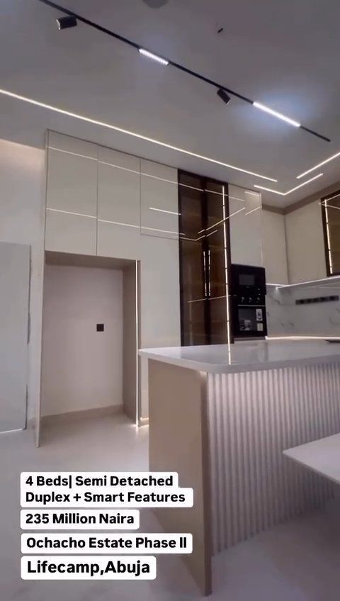 A kitchen with white cabinets and a white counter top.