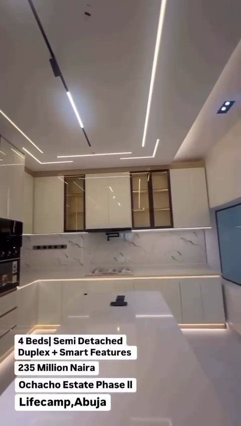 A kitchen with white cabinets and a white counter top
