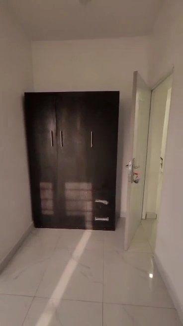 A bathroom with a sink and a shower head.