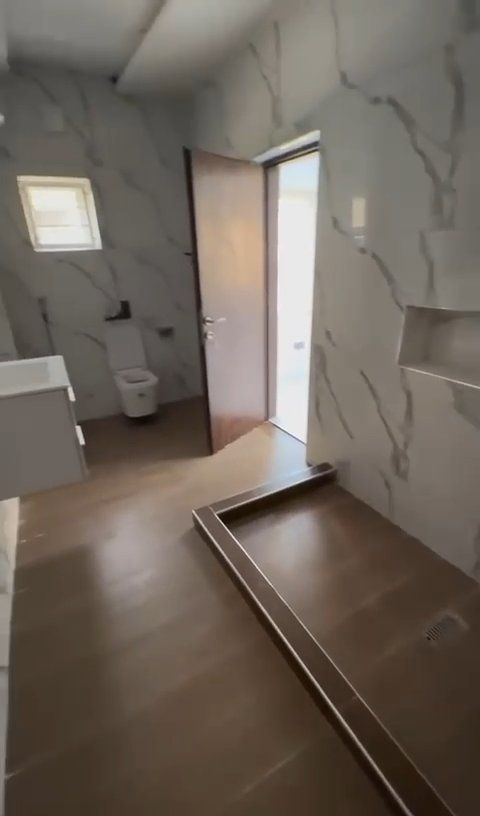 A bathroom with a toilet , sink , and walk in shower.
