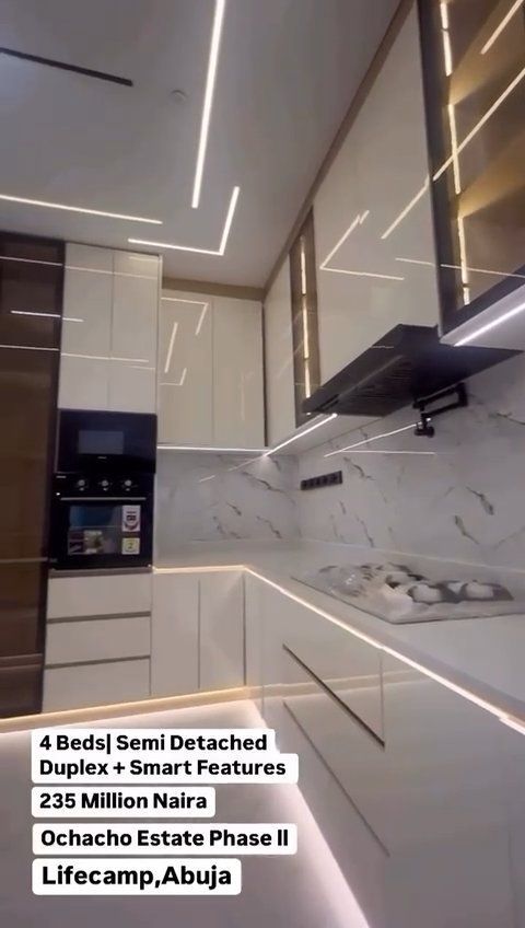 A kitchen with white cabinets and a stove top oven