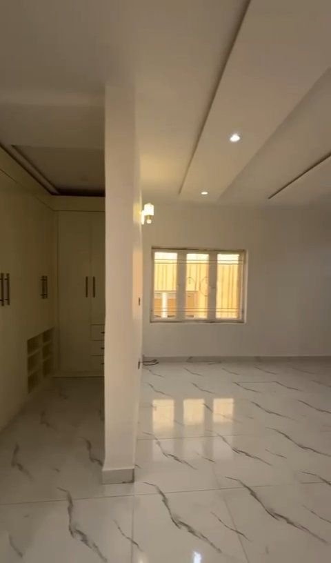 A large empty room with marble floors and a lot of windows.