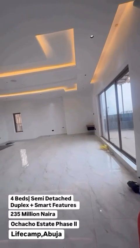 A large room with a lot of windows and lights on the ceiling.