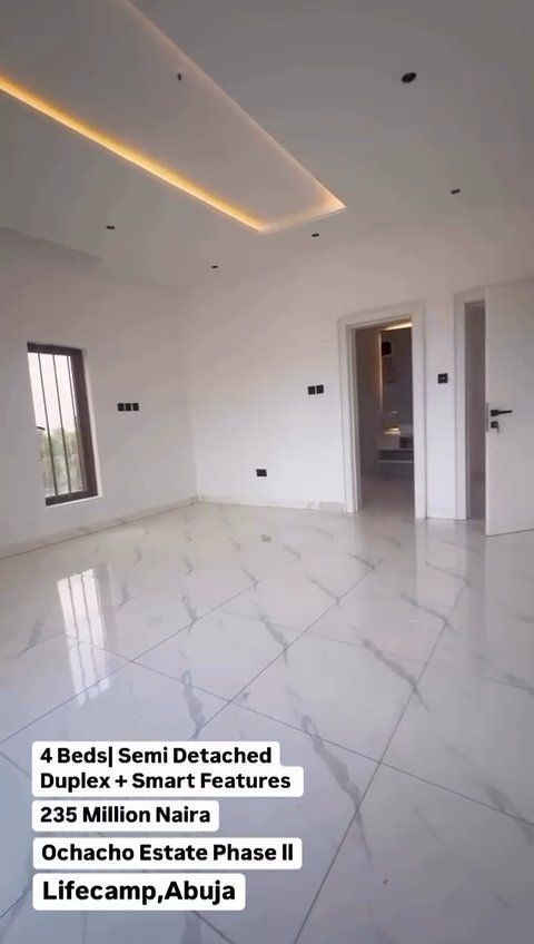 An empty room with a marble floor and a white ceiling