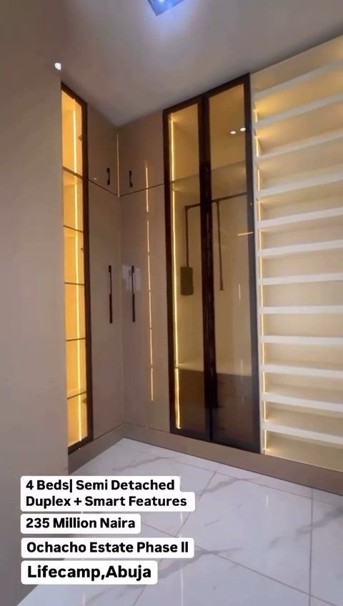 A walk in closet with a lot of shelves and cabinets