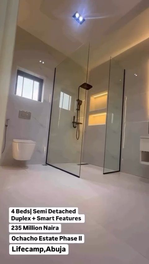 A bathroom with a walk in shower and a toilet