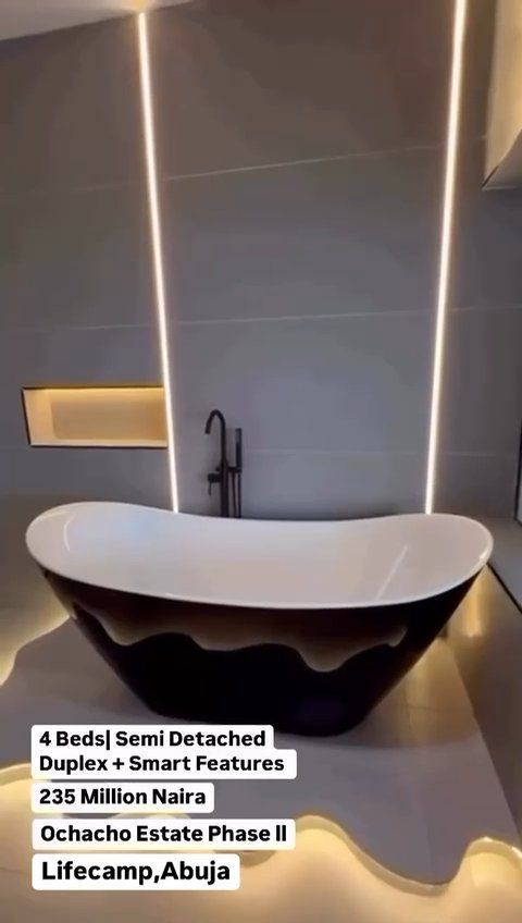A bathroom with a large bathtub and a faucet
