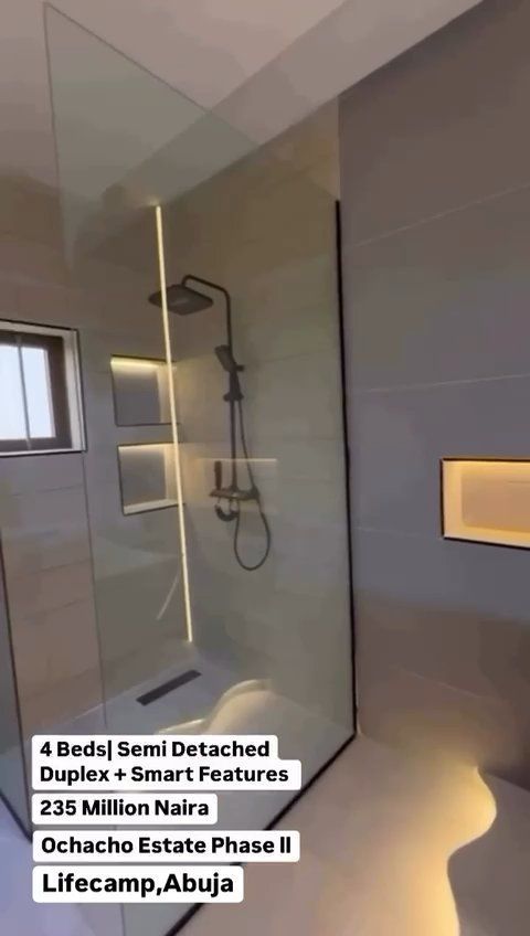 A bathroom with a walk in shower and a shower head