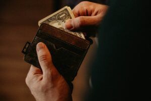 A person is taking money out of their wallet.