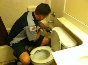 Plumber fixing tap.