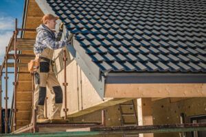 A man is working on the roof of a house.