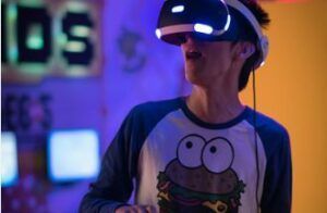 A man wearing a virtual reality headset is playing a video game.
