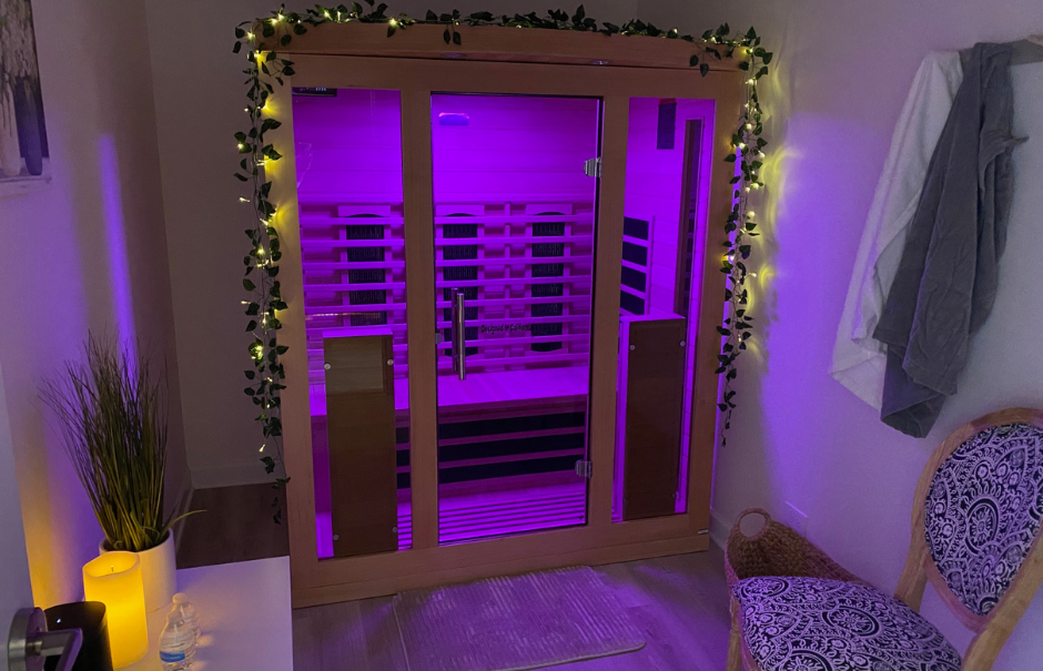 Wooden boxed seating inside an infrared sauna with wooden utensils used inside of the infrared sauna session including towels.