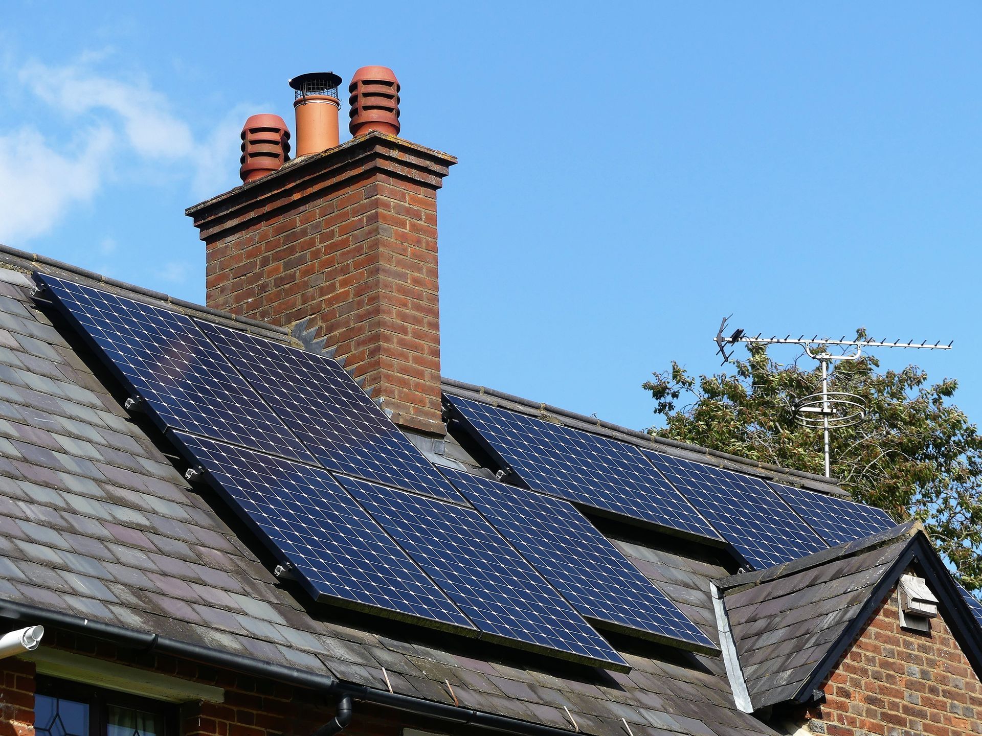 A brick house with solar panels on the roof