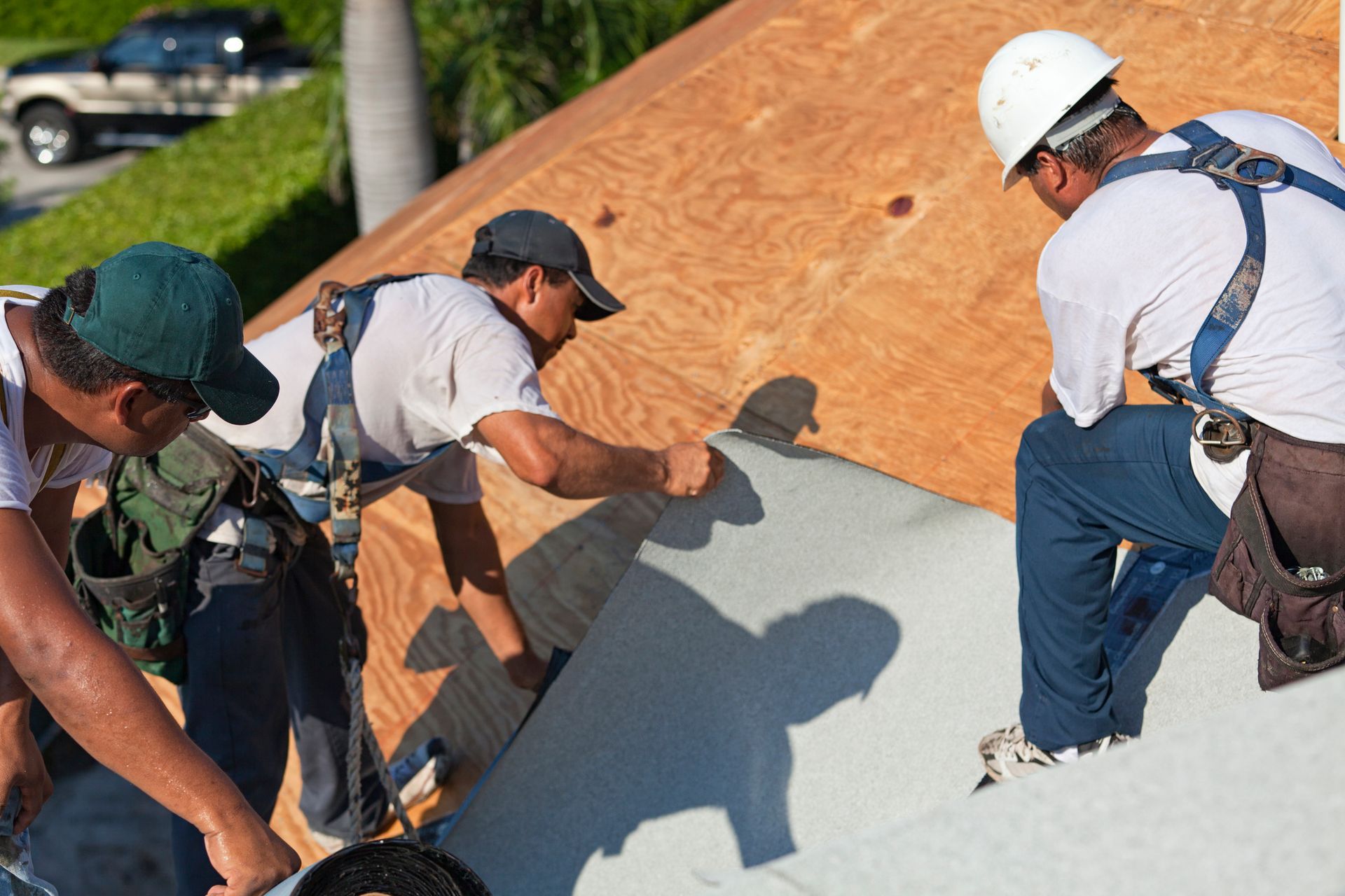 A group of men are working on a roof.